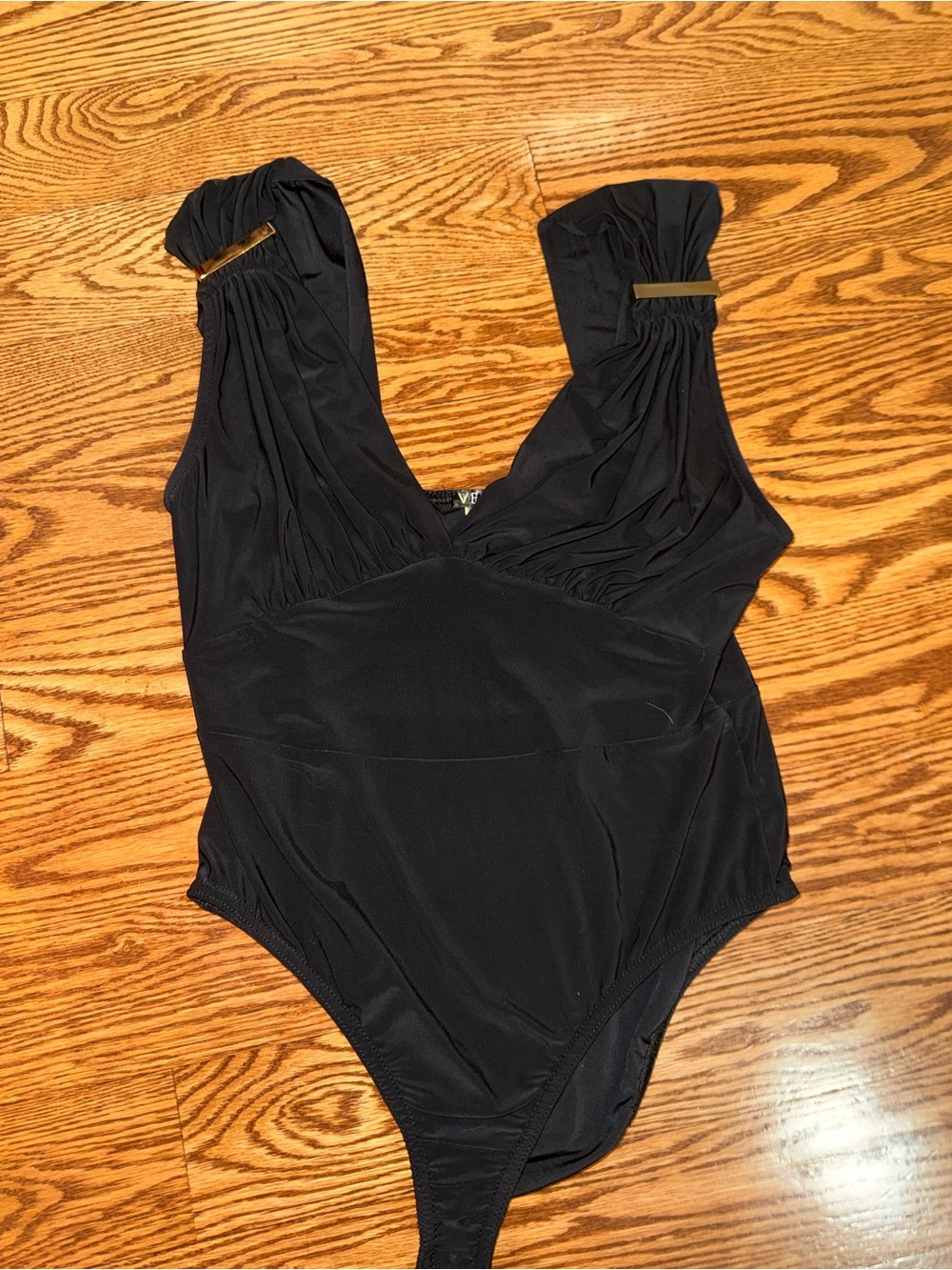 Black One-Piece Bodysuit with Gold Accent